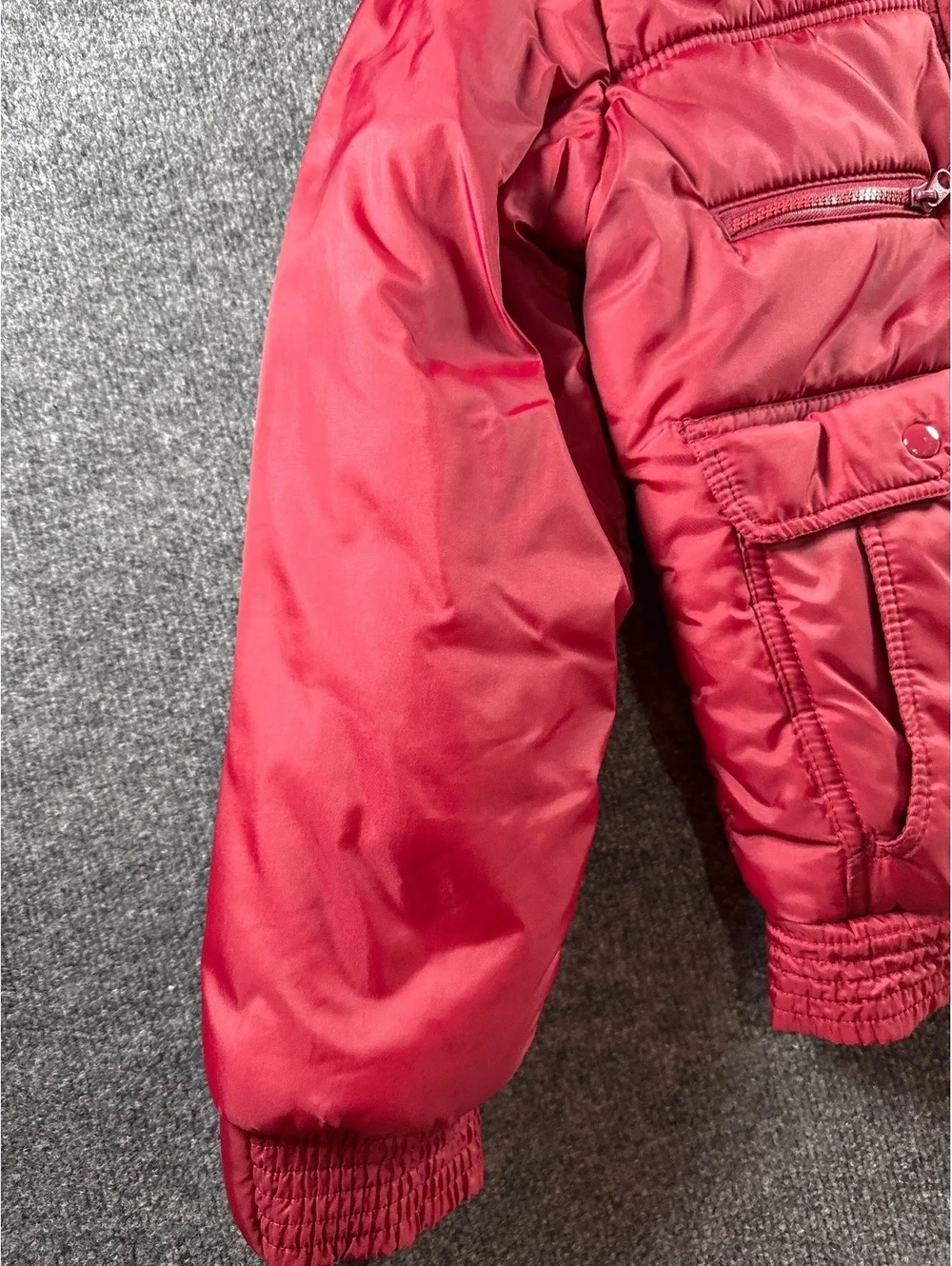 Red Quilted Puffer Jacket with Multiple Pockets and Zip Closure